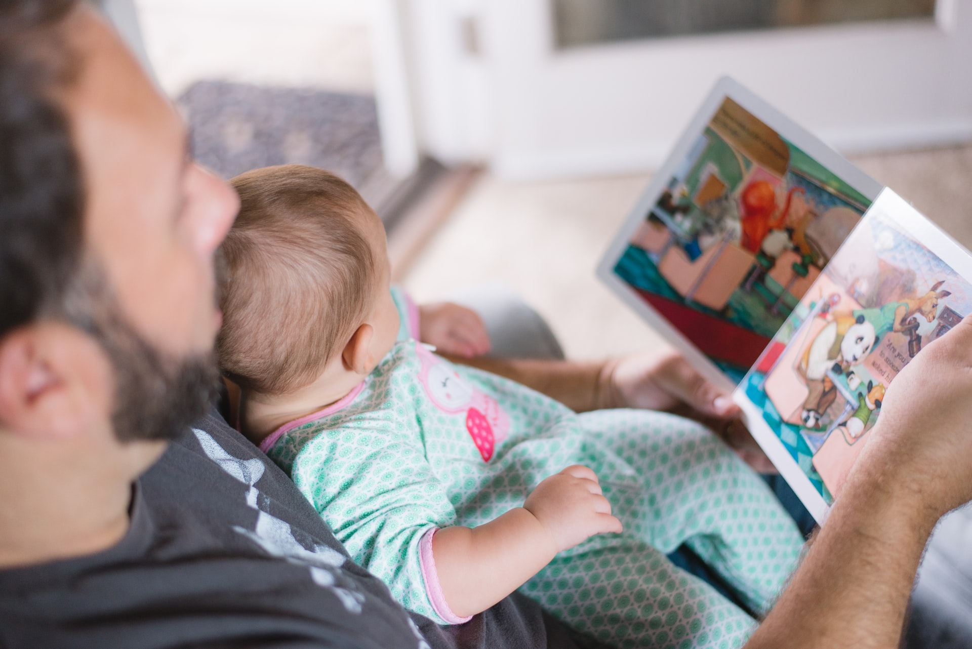 man reading to child
