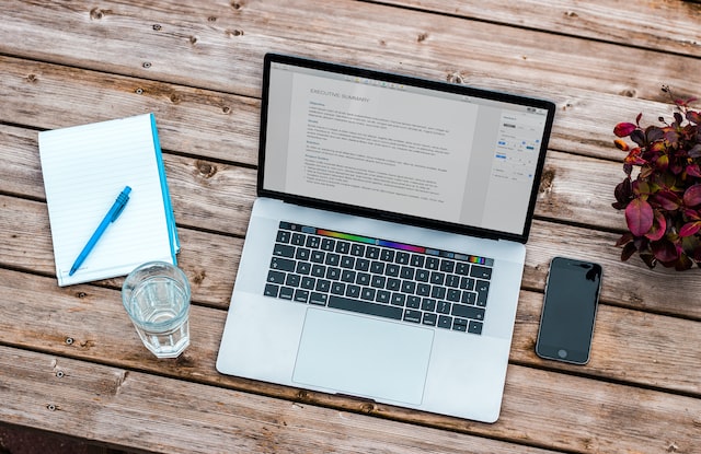writing resume on laptop