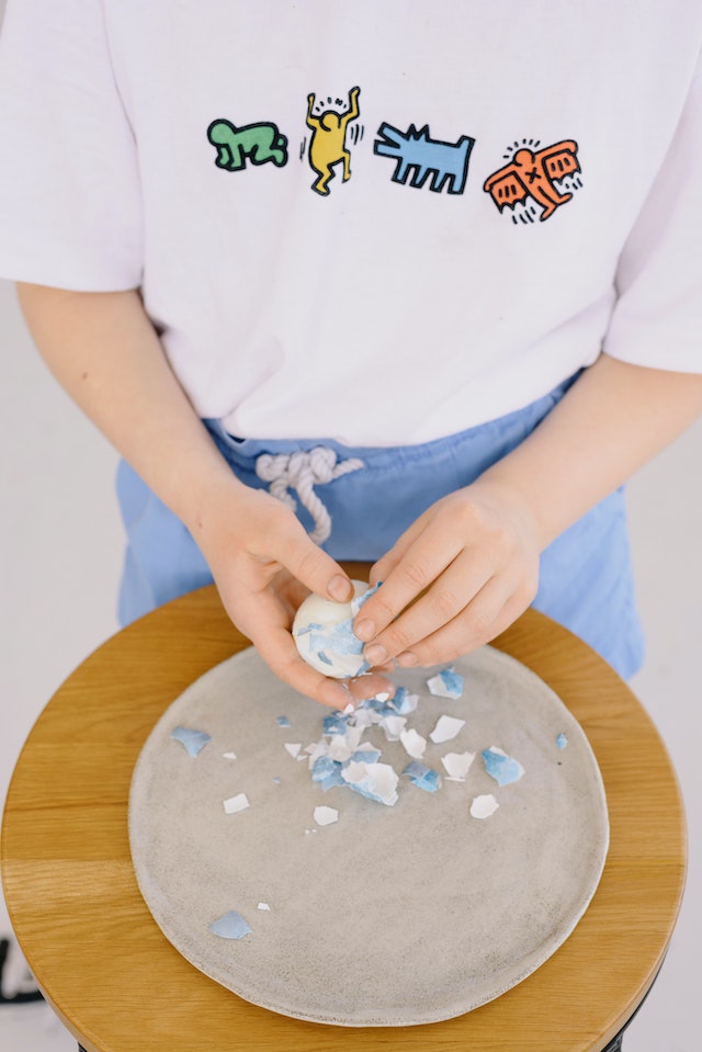 kid holding egg