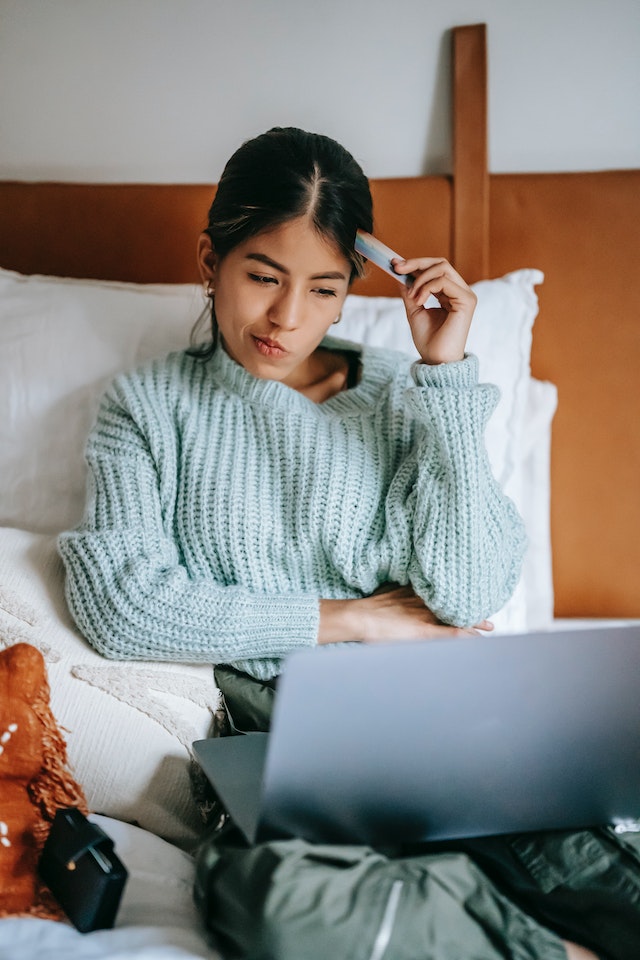 woman considering spending money