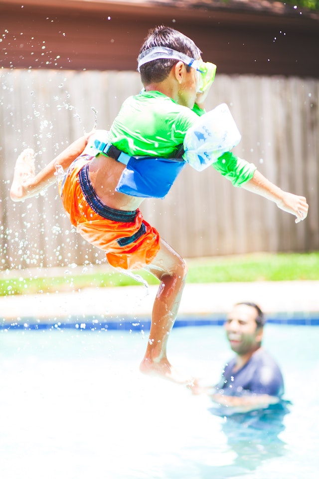 kid jumping into pool 