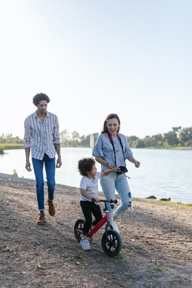 family going on bike ride in summer